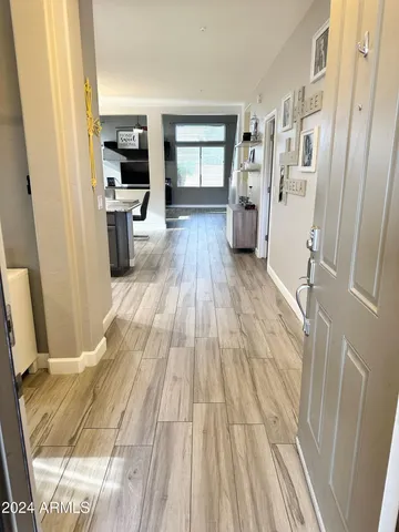 a view of a living room with furniture and wooden floor