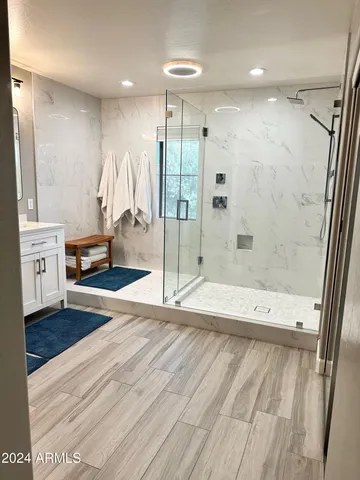 a bathroom with a bathtub and a shower