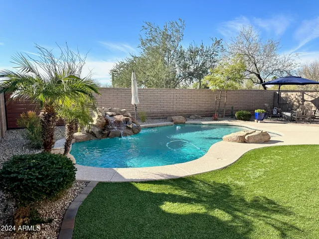 a view of a swimming pool with a yard