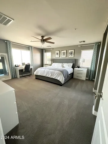 a spacious bedroom with a bed and a couch