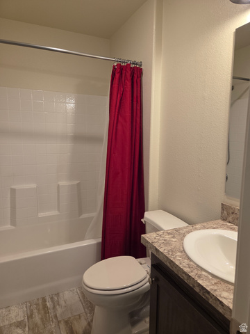1275 Thrush Road Salt Lake City, UT 84123 - Photo 10 of 20 Bathroom featuring a white tub and shower surround, a white toilet, and a vanity