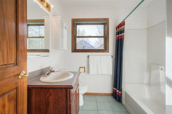 a bathroom with a sink vanity and a bathtub