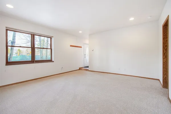 an empty room with a empty space and windows