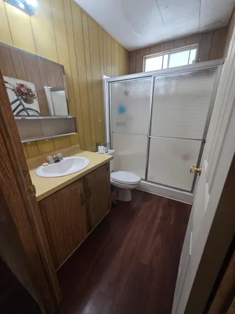 a bathroom with a sink and mirror with toilet