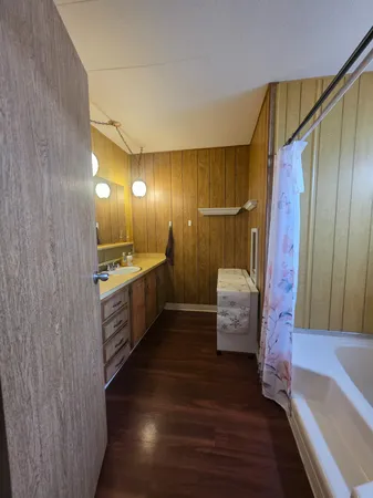 a bathroom with a sink a mirror and shower