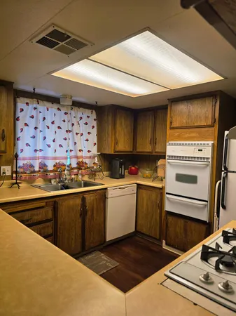 a kitchen with a stove a sink and a refrigerator