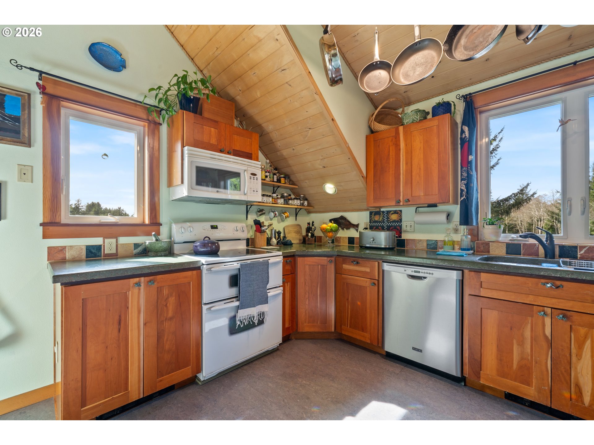 1055 Phelps Street Tillamook, OR 97141 - Photo 16 of 40 a kitchen with stainless steel appliances granite countertop a stove a sink and a microwave