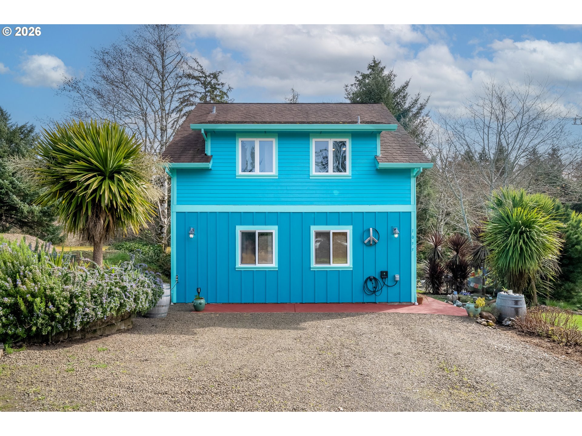 1055 Phelps Street Tillamook, OR 97141 - Photo 2 of 40 a house that has a tree in front of it