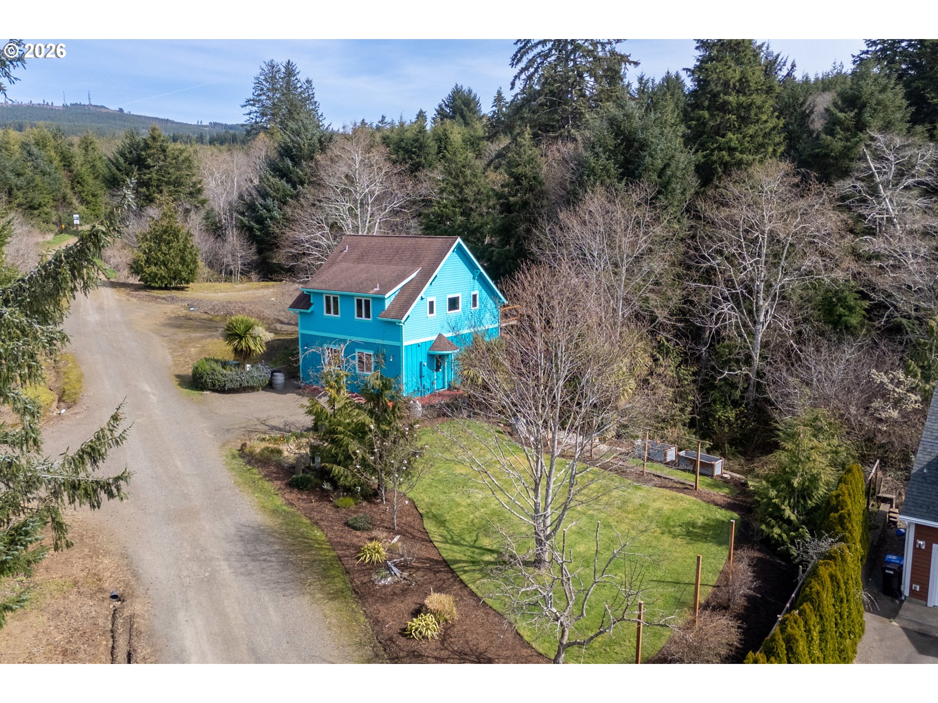 1055 Phelps Street Tillamook, OR 97141 - Photo 3 of 40 a view of a house with a yard and a trees