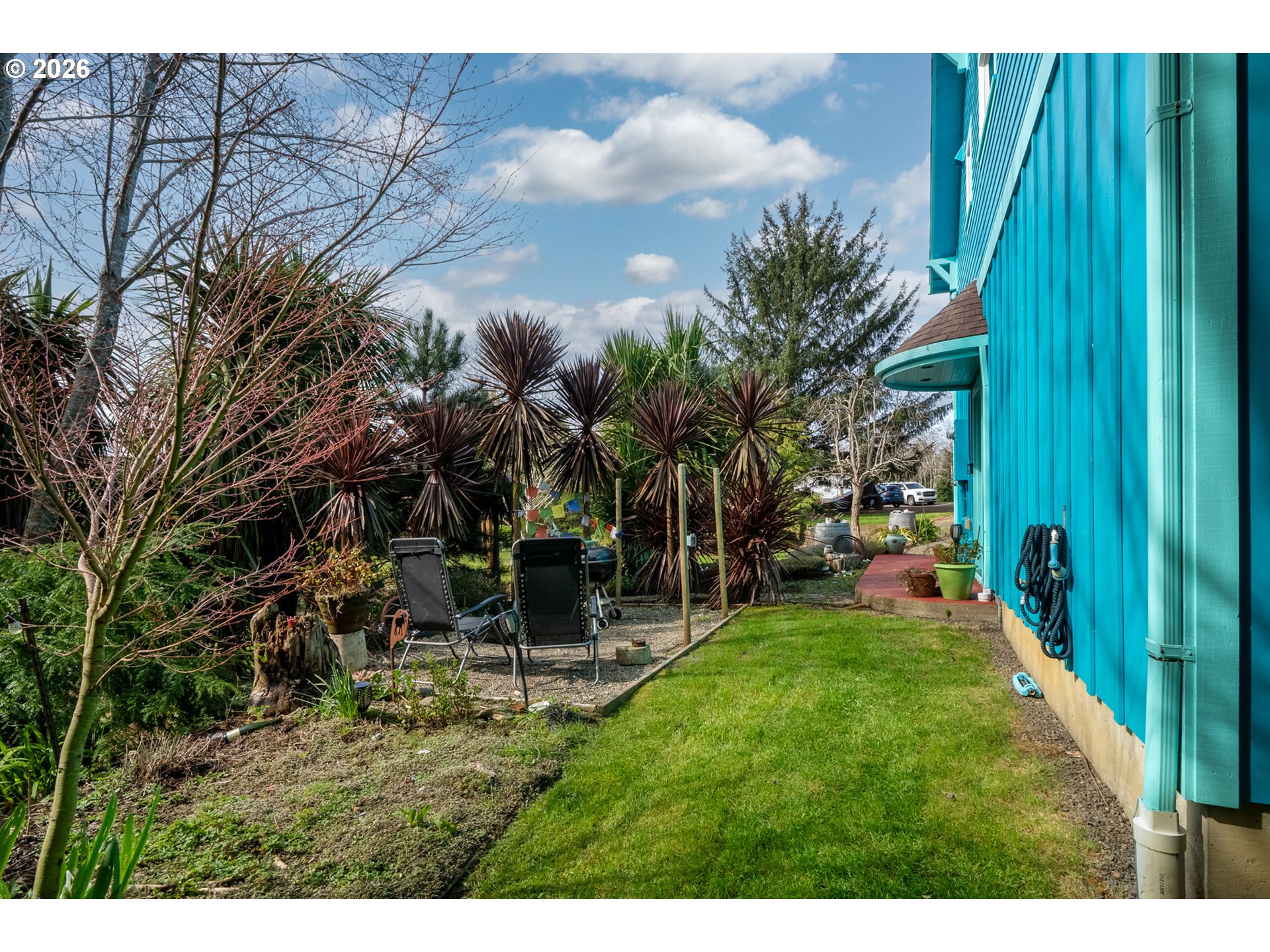 1055 Phelps Street Tillamook, OR 97141 - Photo 36 of 40 a backyard of a house with table and chairs