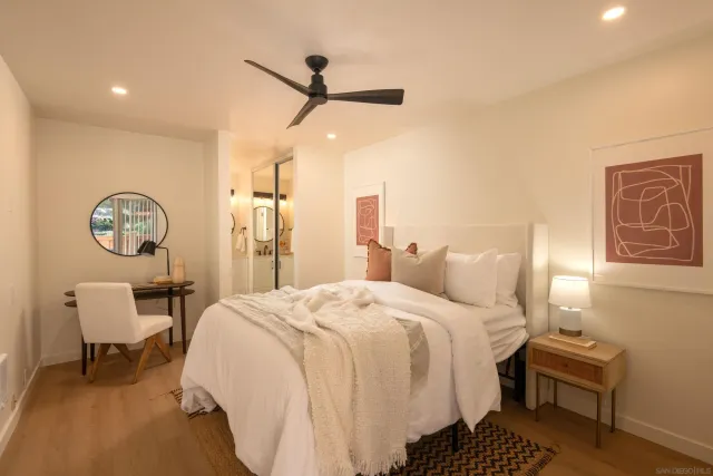 a bedroom with a bed a desk and chair