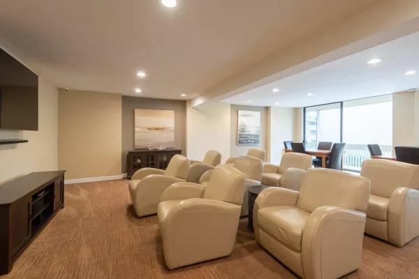 a room with pool table and windows