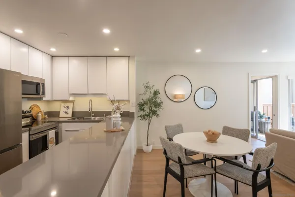 a large kitchen with a table and chairs in it