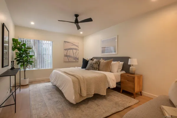 a spacious bedroom with a bed and a large window