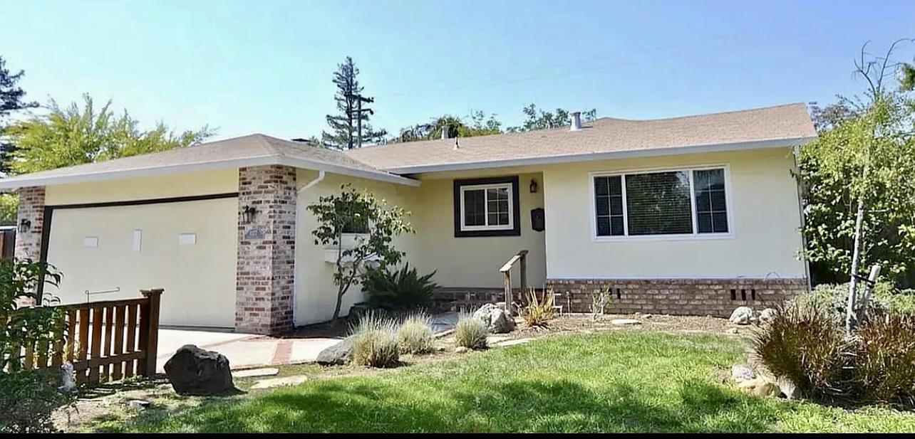 a front view of a house with garden