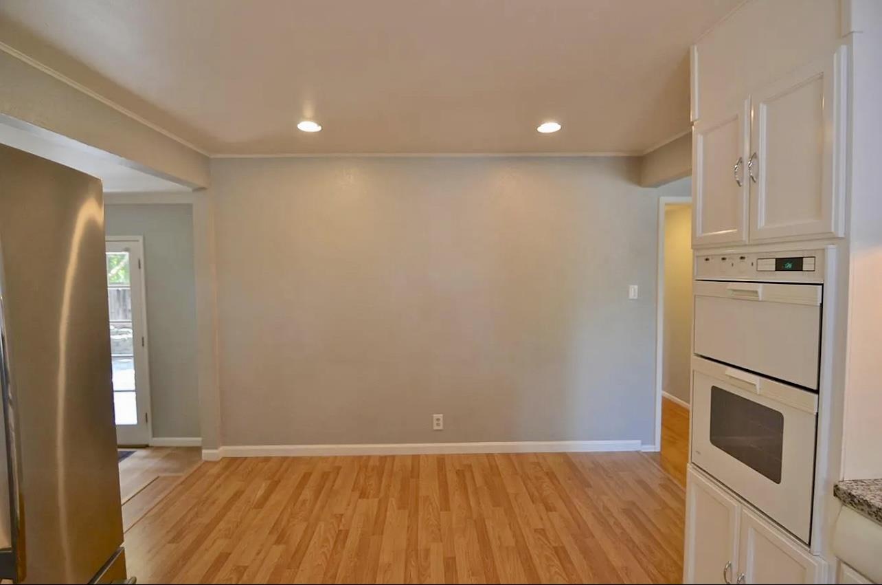 1377 Virginia Avenue Campbell, CA 95008 - Photo 9 of 29 a view of an empty room with wooden floor and a kitchen