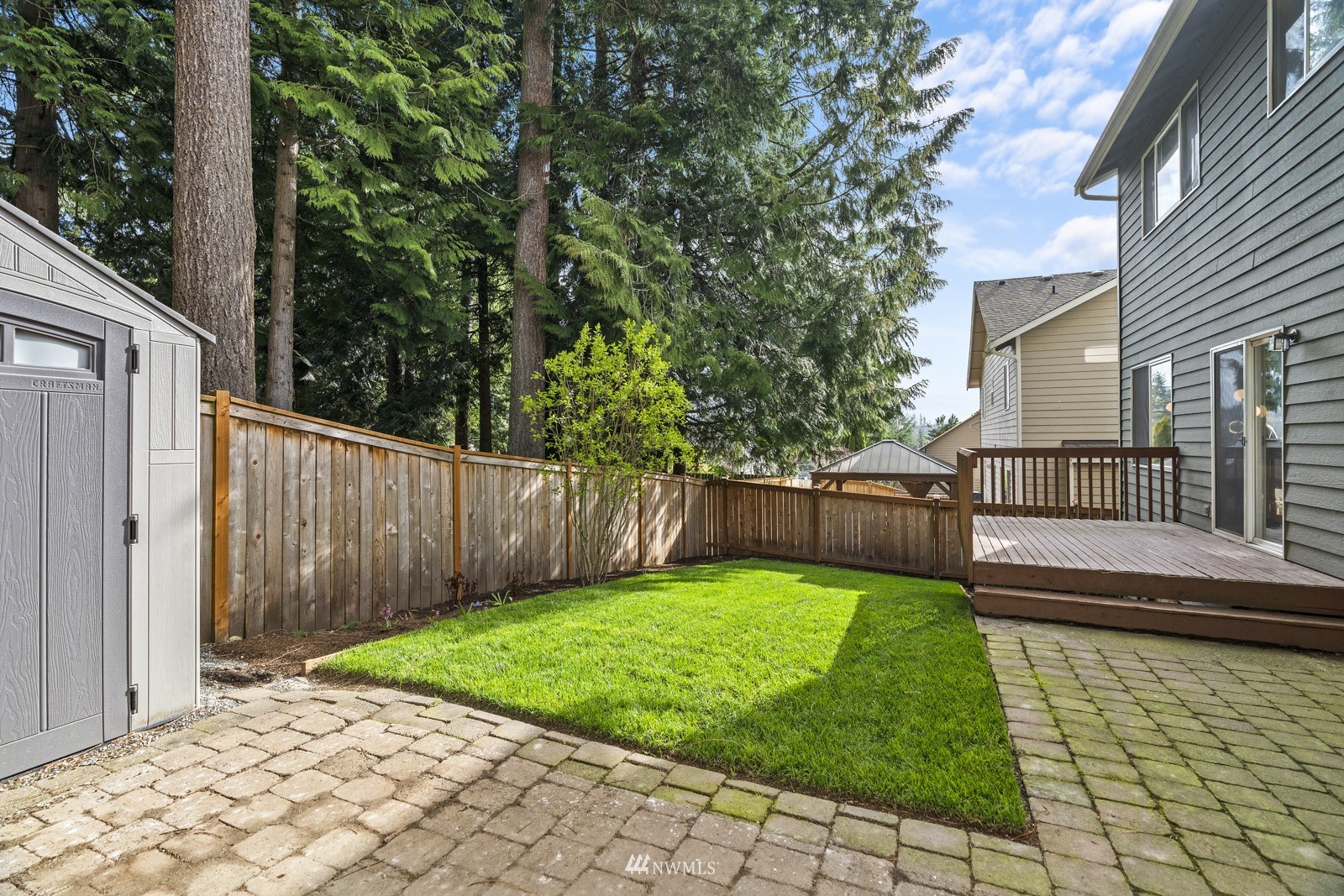213 169th Street Southeast Bothell, WA 98012 - Photo 27 of 29 a view of a backyard with table and chairs and wooden fence