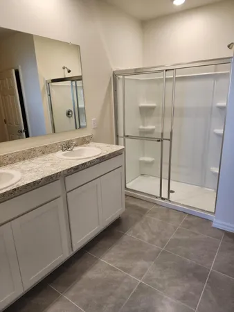 a bathroom with a granite countertop sink a mirror and a vanity