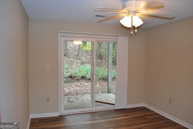 a view of a hallway with wooden floor and chandelier