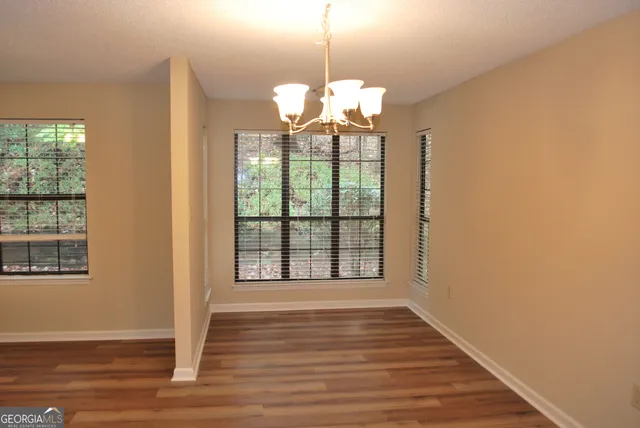 a view of a room with wooden floor and fan