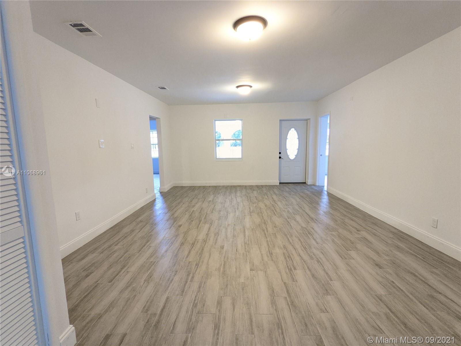 5675 Southwest 5th Street Miami, FL 33134 - Photo 12 of 20 wooden floor in an empty room with a window
