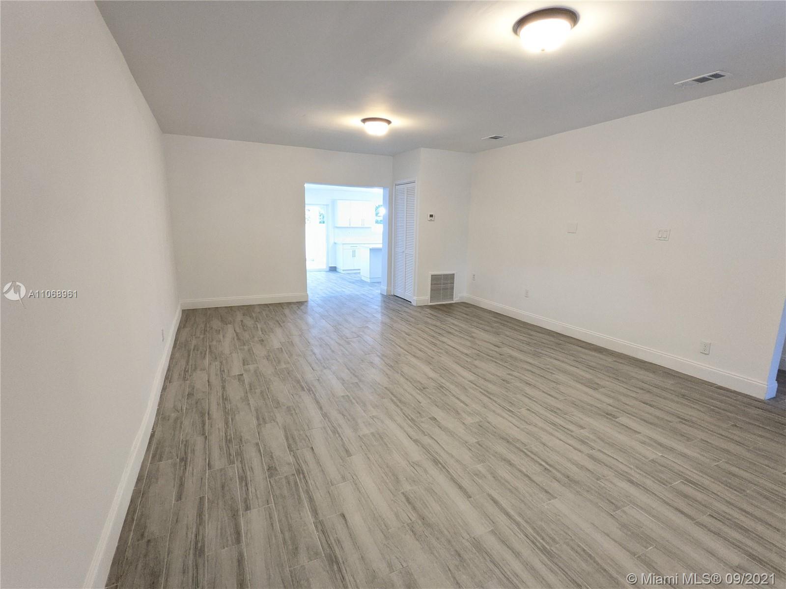5675 Southwest 5th Street Miami, FL 33134 - Photo 13 of 20 an empty room with wooden floor and windows