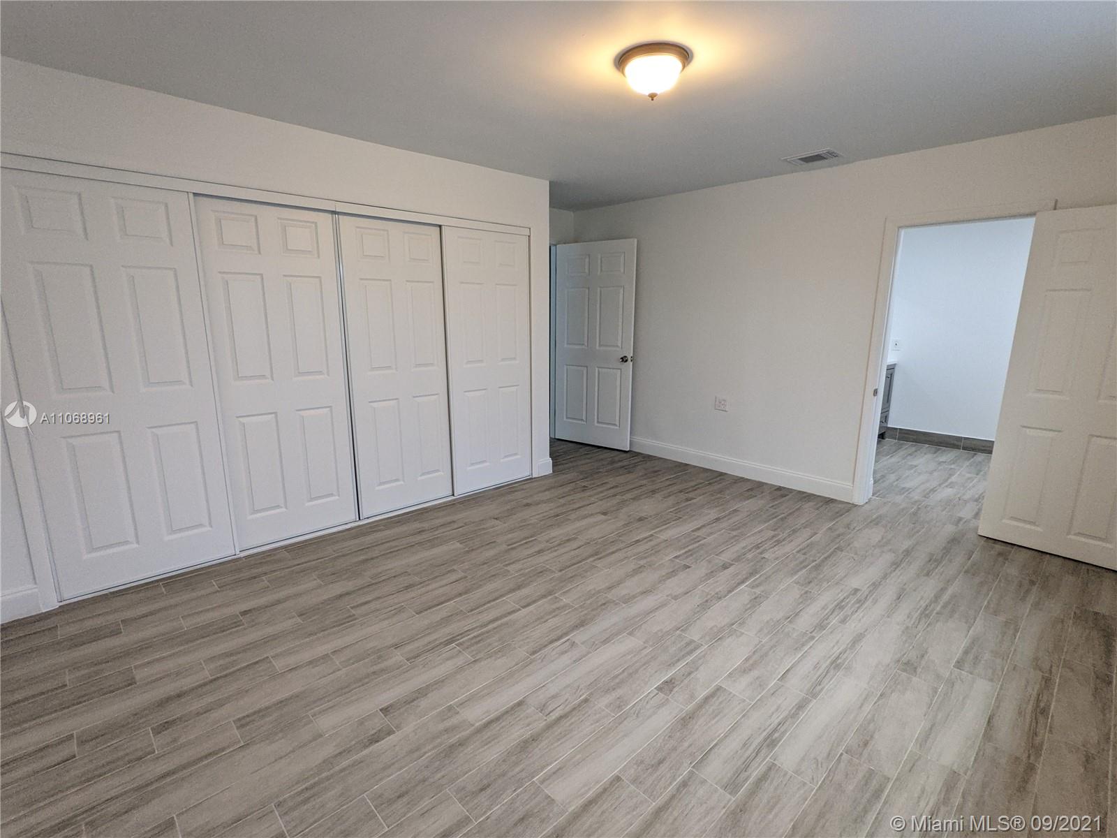 5675 Southwest 5th Street Miami, FL 33134 - Photo 14 of 20 a view of an empty room with wooden floor