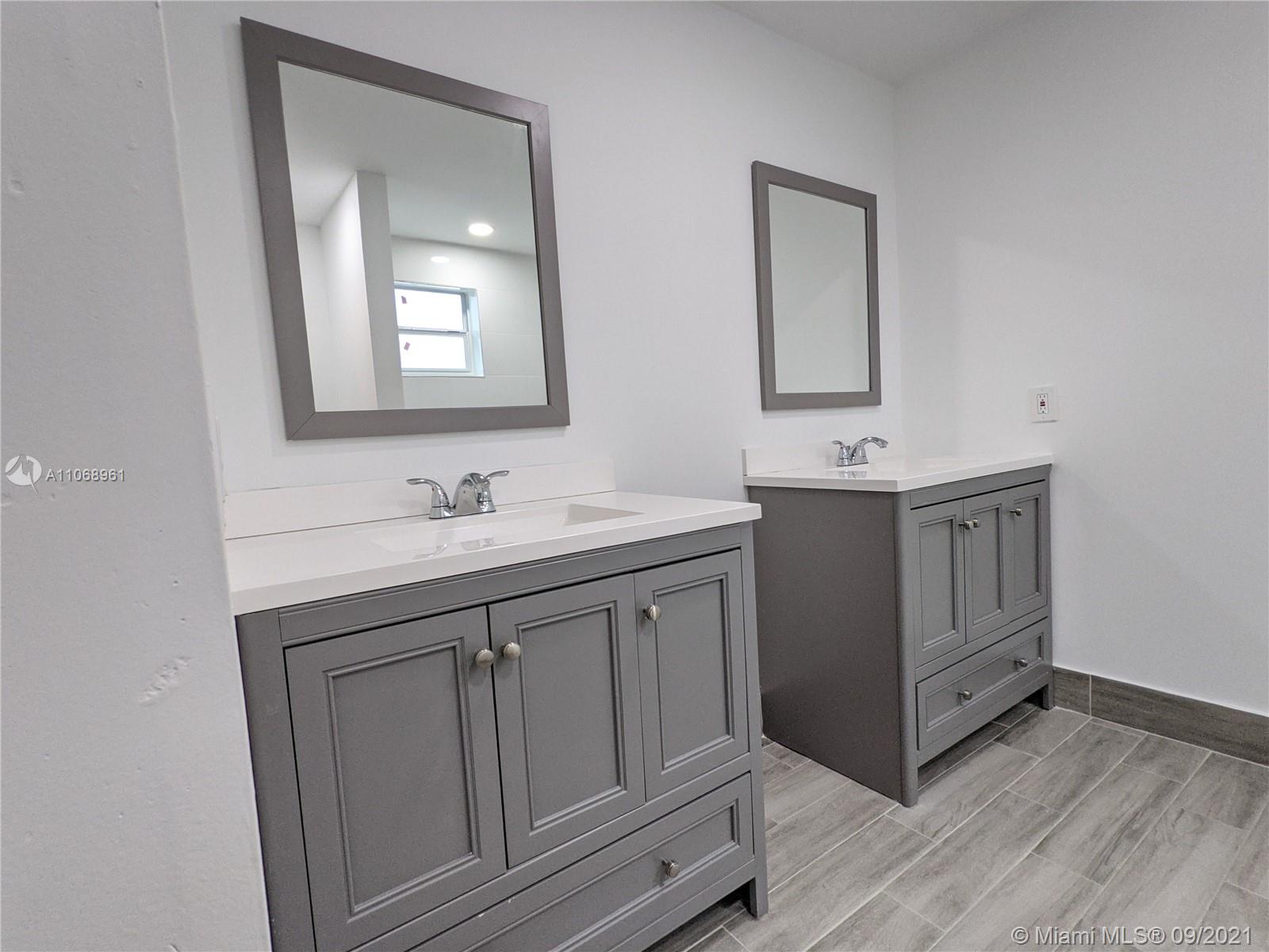 5675 Southwest 5th Street Miami, FL 33134 - Photo 15 of 20 a bathroom with a double vanity sink and mirror