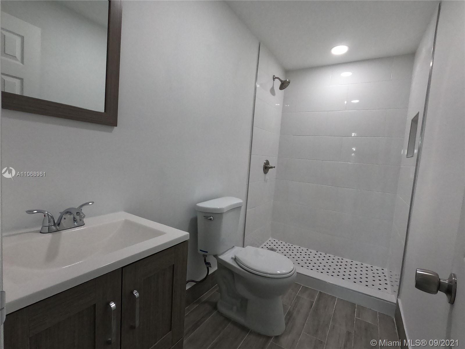 5675 Southwest 5th Street Miami, FL 33134 - Photo 17 of 20 a bathroom with a sink a toilet and shower