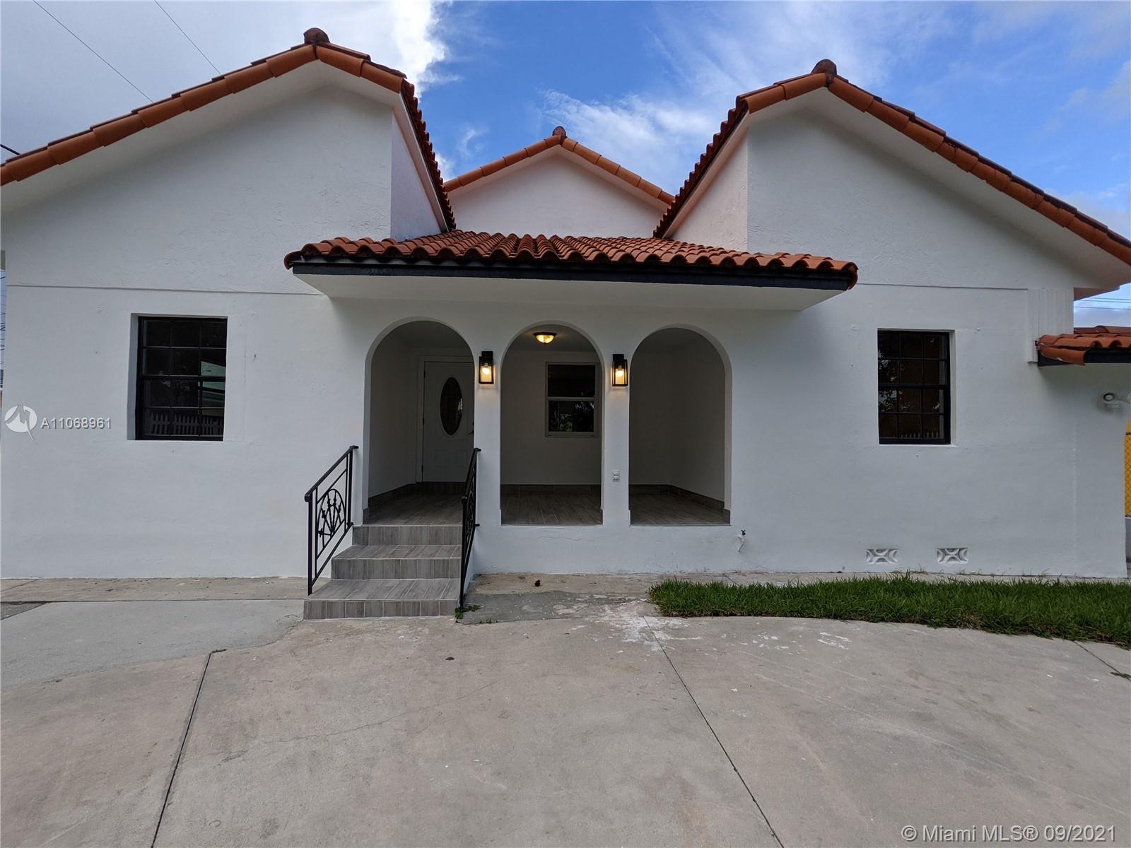 5675 Southwest 5th Street Miami, FL 33134 - Photo 3 of 20 a front view of a house with large windows