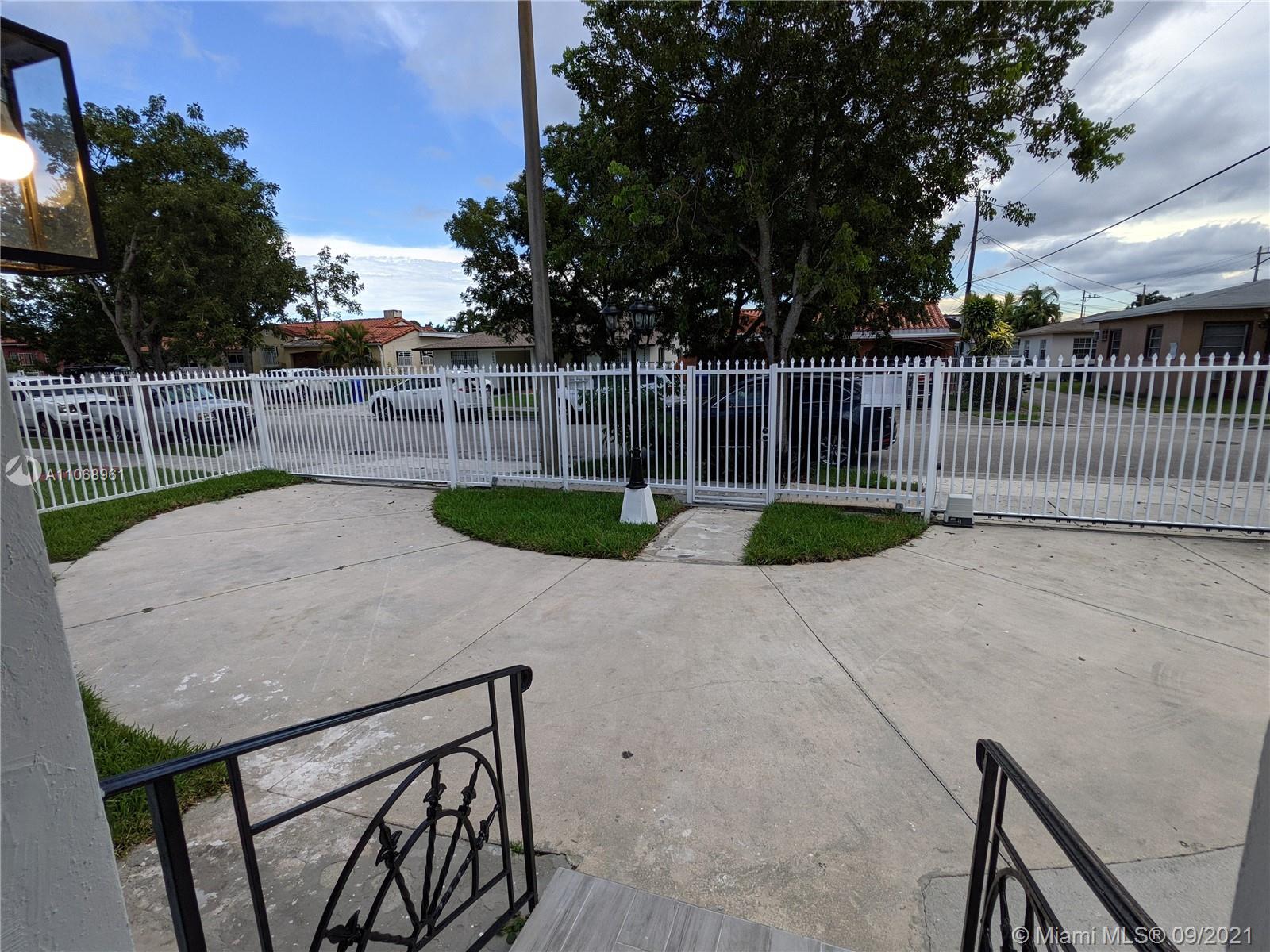 5675 Southwest 5th Street Miami, FL 33134 - Photo 4 of 20 a view of backyard with small cabin and wooden fence