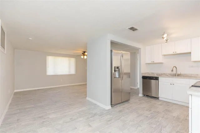 a view of a kitchen with a sink cabinets and a window