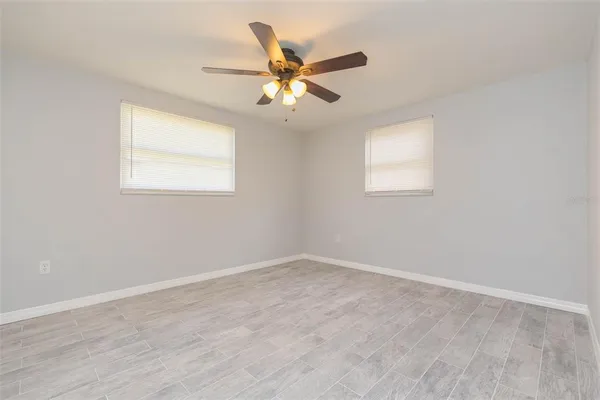 an a ceiling fan and window in a room