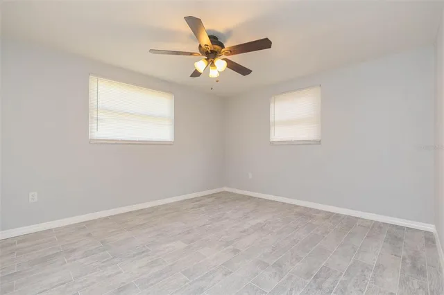 an a ceiling fan and window in a room