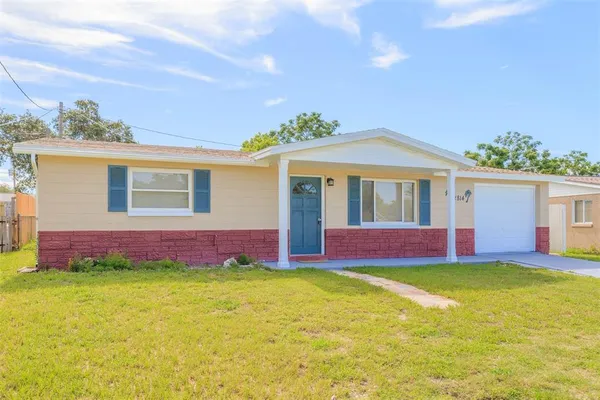 a front view of house with yard and outdoor seating