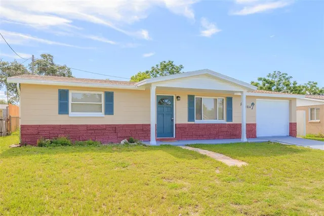 a front view of house with yard and outdoor seating