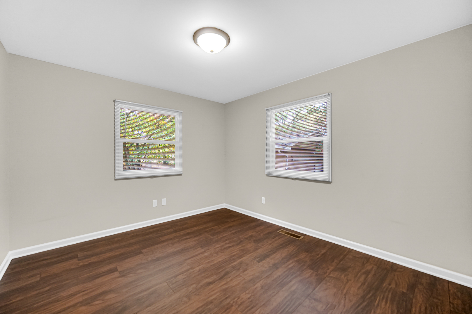 6226 East 250S Road St. Anne, IL 60964 - Photo 20 of 22 a view of a big room with wooden floor and windows