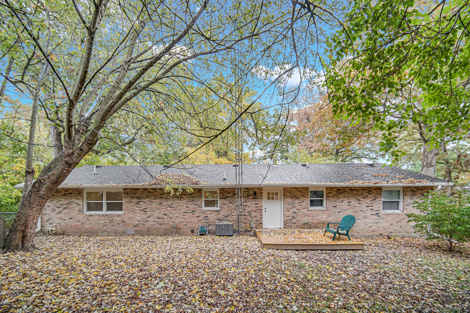 6226 East 250S Road St. Anne, IL 60964 - Photo 22 of 22 a backyard of a house with table and chairs under an umbrella