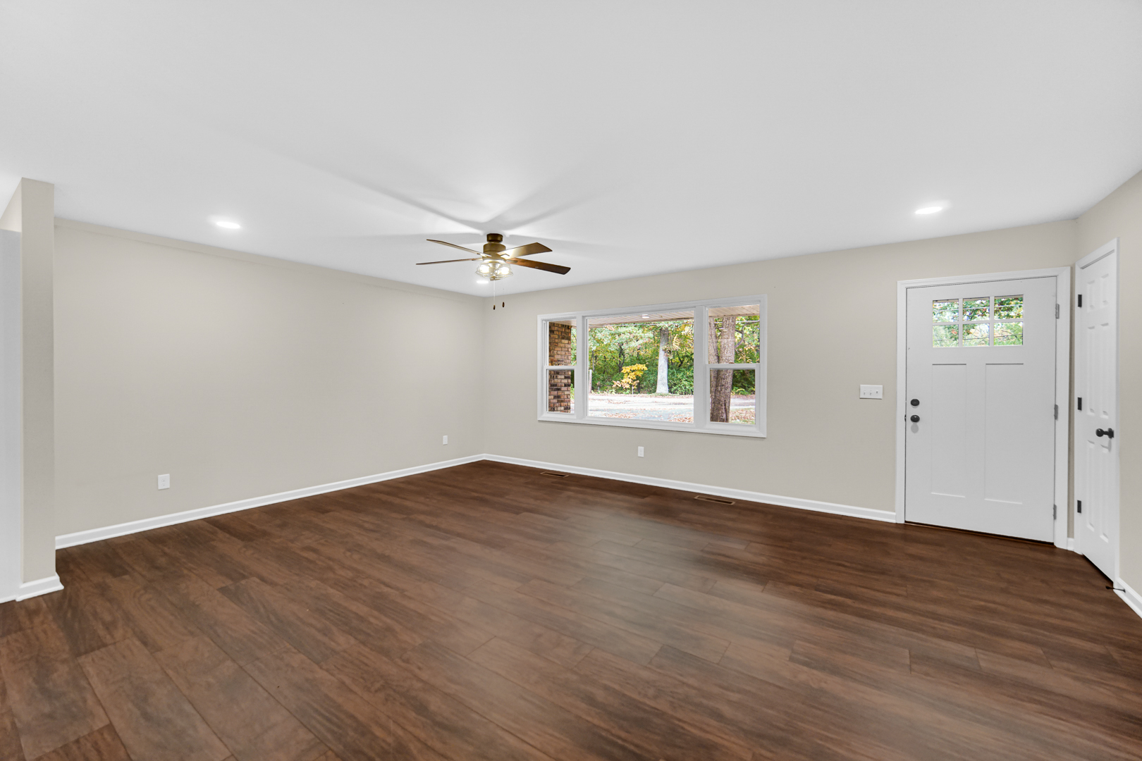 6226 East 250S Road St. Anne, IL 60964 - Photo 4 of 22 an empty room with wooden floor chandelier fan and windows