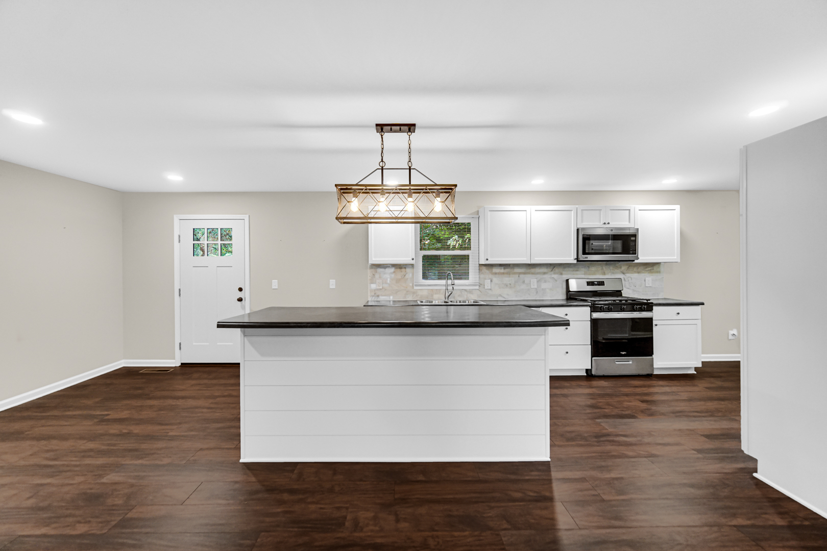 6226 East 250S Road St. Anne, IL 60964 - Photo 8 of 22 a kitchen with stainless steel appliances granite countertop a stove a sink and a refrigerator