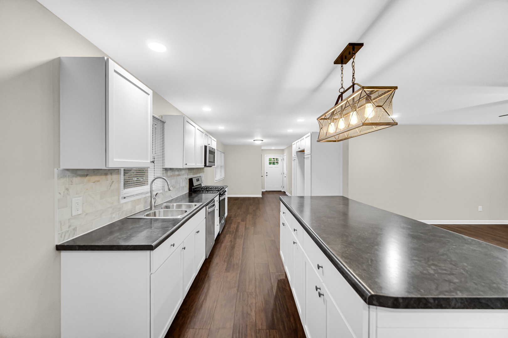 6226 East 250S Road St. Anne, IL 60964 - Photo 9 of 22 a large kitchen with stainless steel appliances granite countertop a sink a stove and a refrigerator