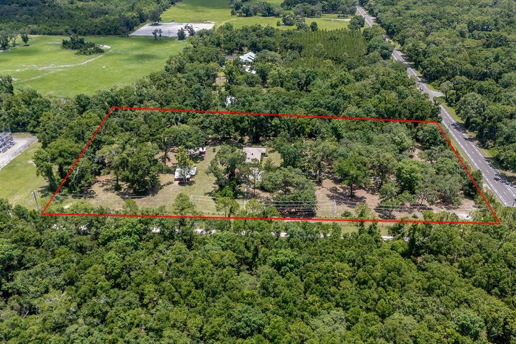 8991 Northwest 115th Street Chiefland, FL 32626 - Photo 21 of 49 an aerial view of residential house with outdoor space and trees all around