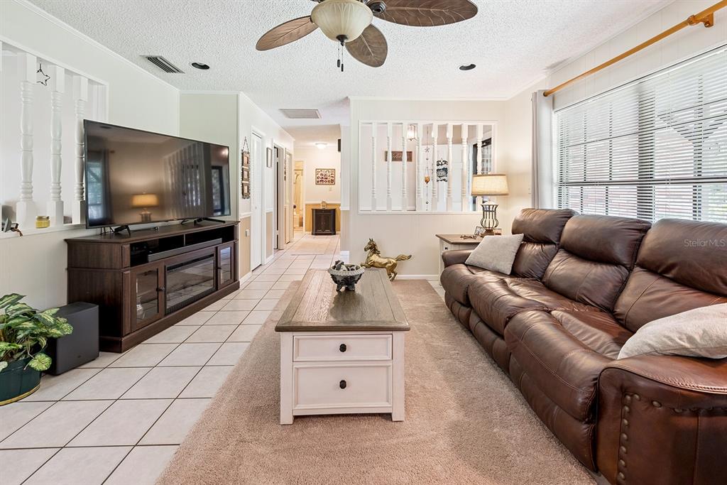 8991 Northwest 115th Street Chiefland, FL 32626 - Photo 29 of 49 a living room with furniture and a flat screen tv