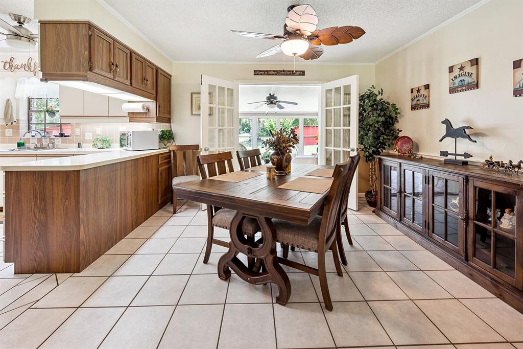 8991 Northwest 115th Street Chiefland, FL 32626 - Photo 30 of 49 a kitchen with stainless steel appliances kitchen island granite countertop a sink and cabinets