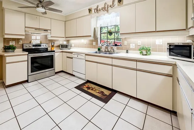 a kitchen with a stove a sink and a refrigerator