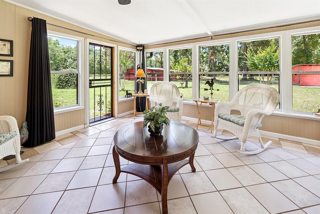 8991 Northwest 115th Street Chiefland, FL 32626 - Photo 38 of 49 a living room with furniture and a floor to ceiling window