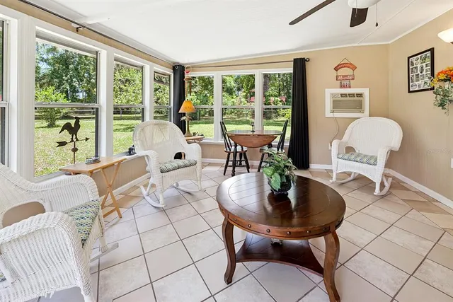 a spacious bedroom with a bed and a dresser next to a window