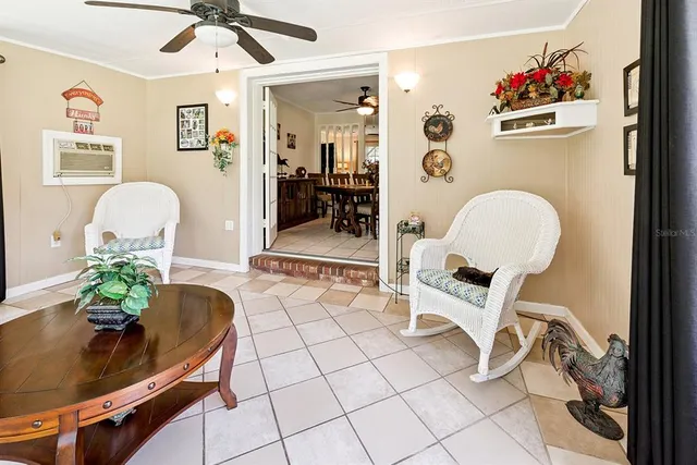 a bedroom with a bed and large windows