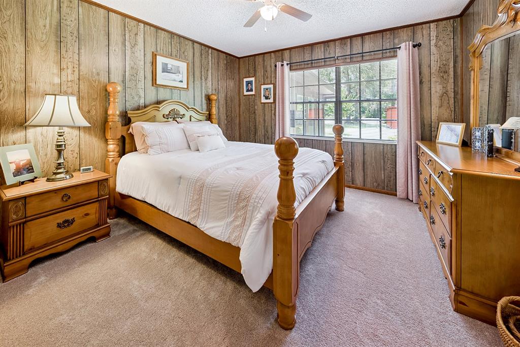 8991 Northwest 115th Street Chiefland, FL 32626 - Photo 41 of 49 a spacious bedroom with a bed and a dresser next to a window