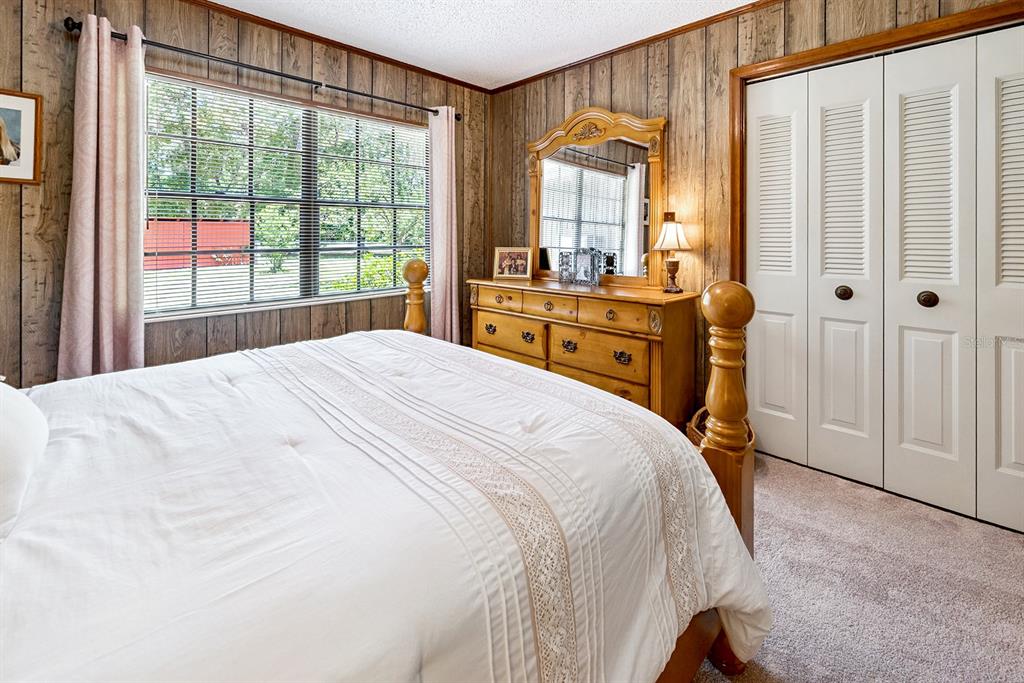 8991 Northwest 115th Street Chiefland, FL 32626 - Photo 42 of 49 a bedroom with a bed and large windows